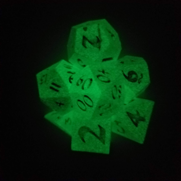 Seven glowing dice in the dark.